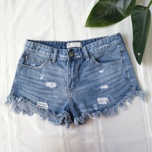 Free People medium wash distressed and frayed shorts
